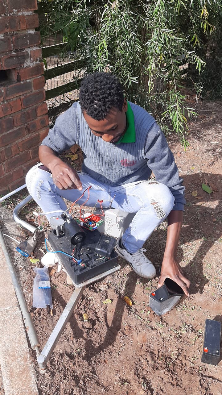 Entechnical technician servicing a gate motor circuit board