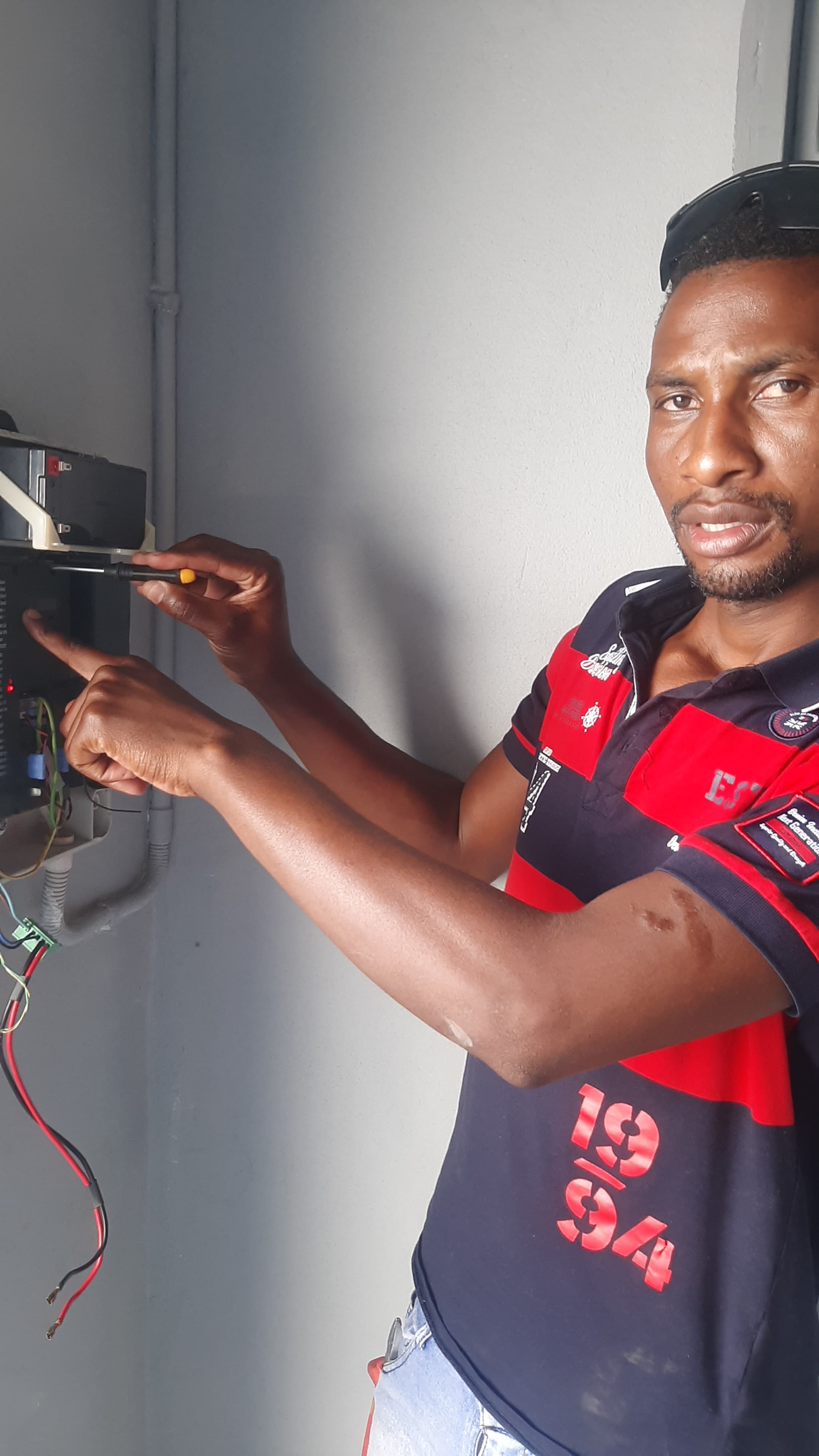 Entechnical Solutions technician repairing a gate motor control board on site in Durban